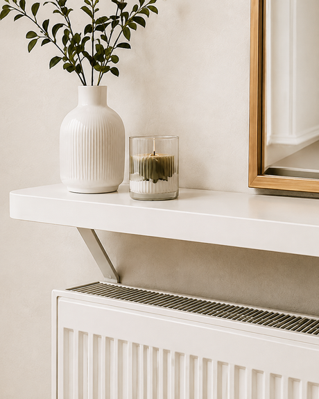 White Loby radiator shelf mounted above a radiator, with the support bracket running down behind it