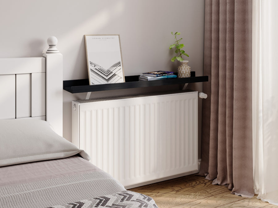 Black — Loby Edge radiator shelf in black, fitted above a radiator in a home interior