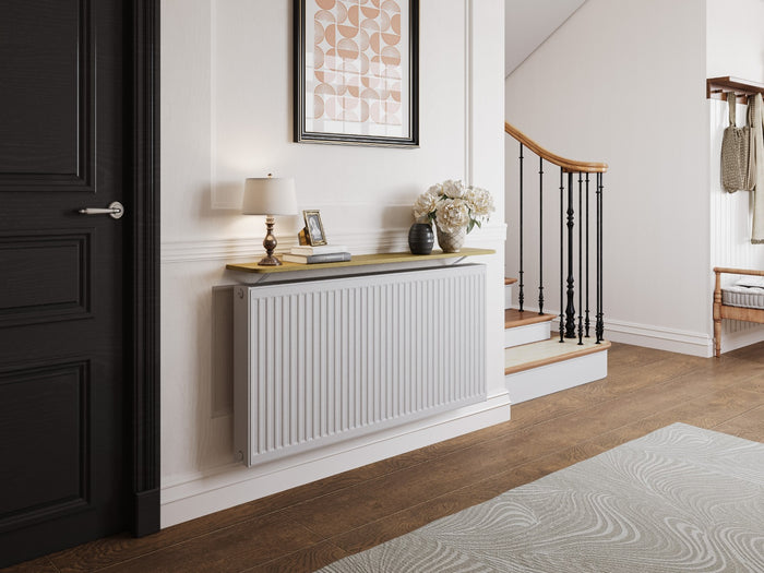 A hallway with a shelf above the radiator