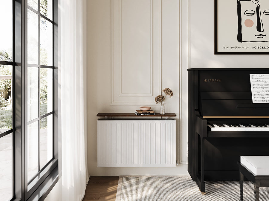 A Loby radiator shelf styled above a radiator in a living room