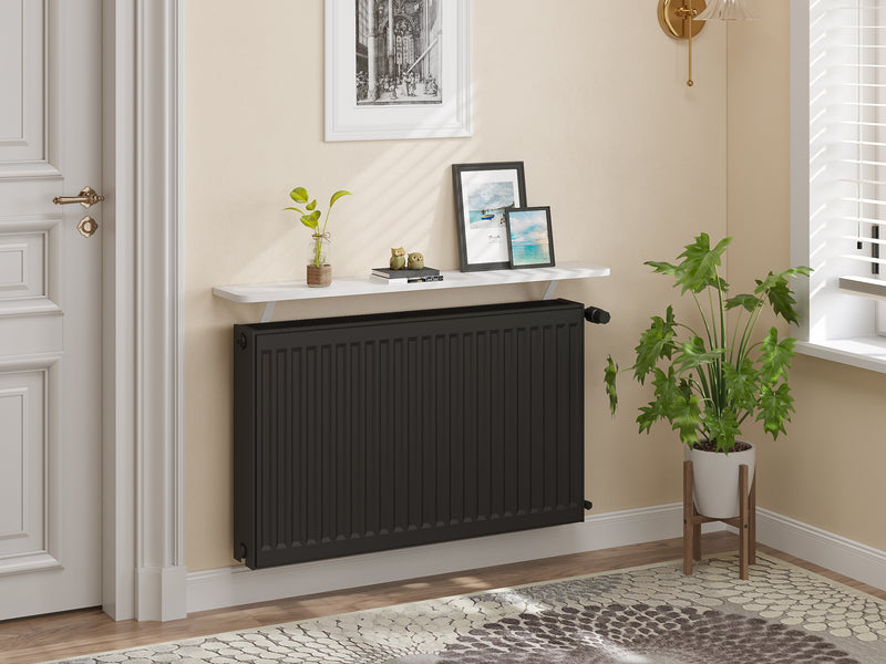 Loby Thermal radiator shelf in white above a black radiator in a bright UK hallway