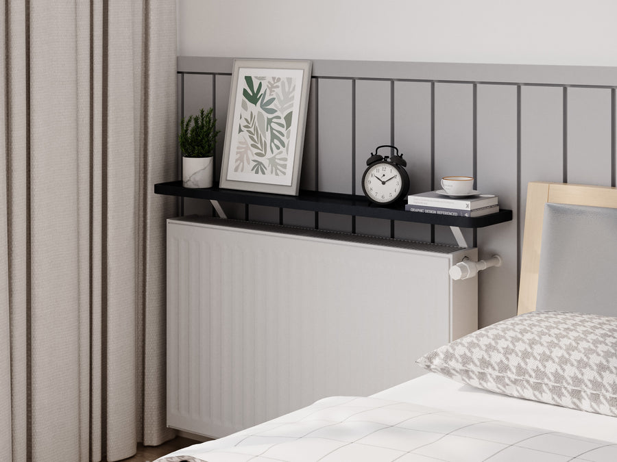 Black — Loby Curve radiator shelf in black, fitted above a radiator in a home interior