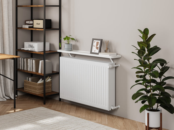 White — Loby Curve radiator shelf in white, fitted above a radiator in a home interior