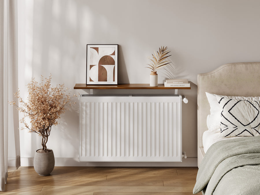 Pine — Pine radiator shelf in the pine finish, fitted above a radiator in a bedroom with dried stems
